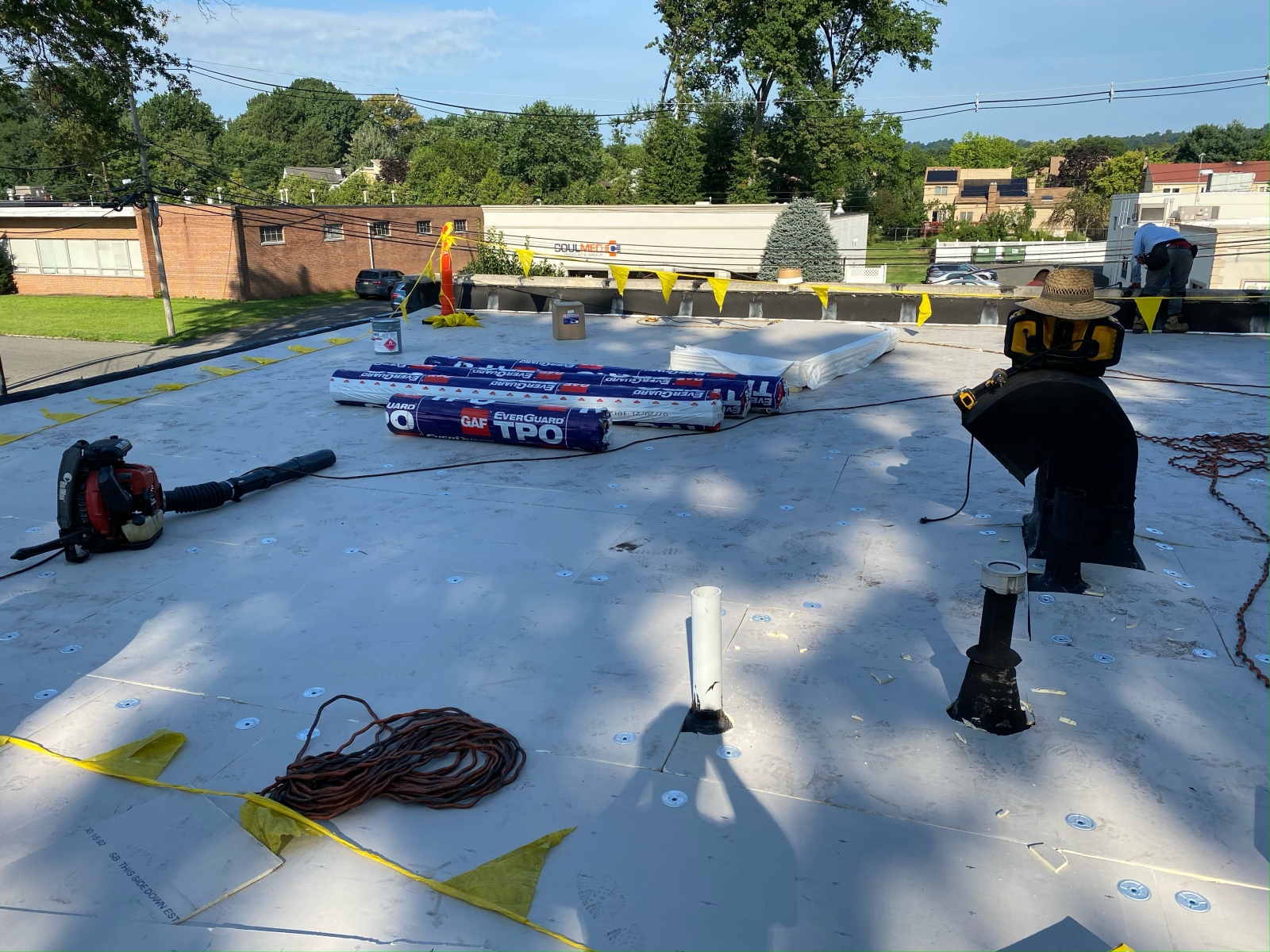 work being done on a TPO roofing system