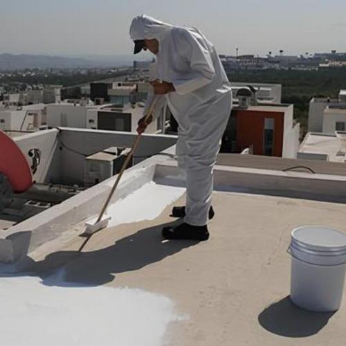 worker applying a rubber roof coating