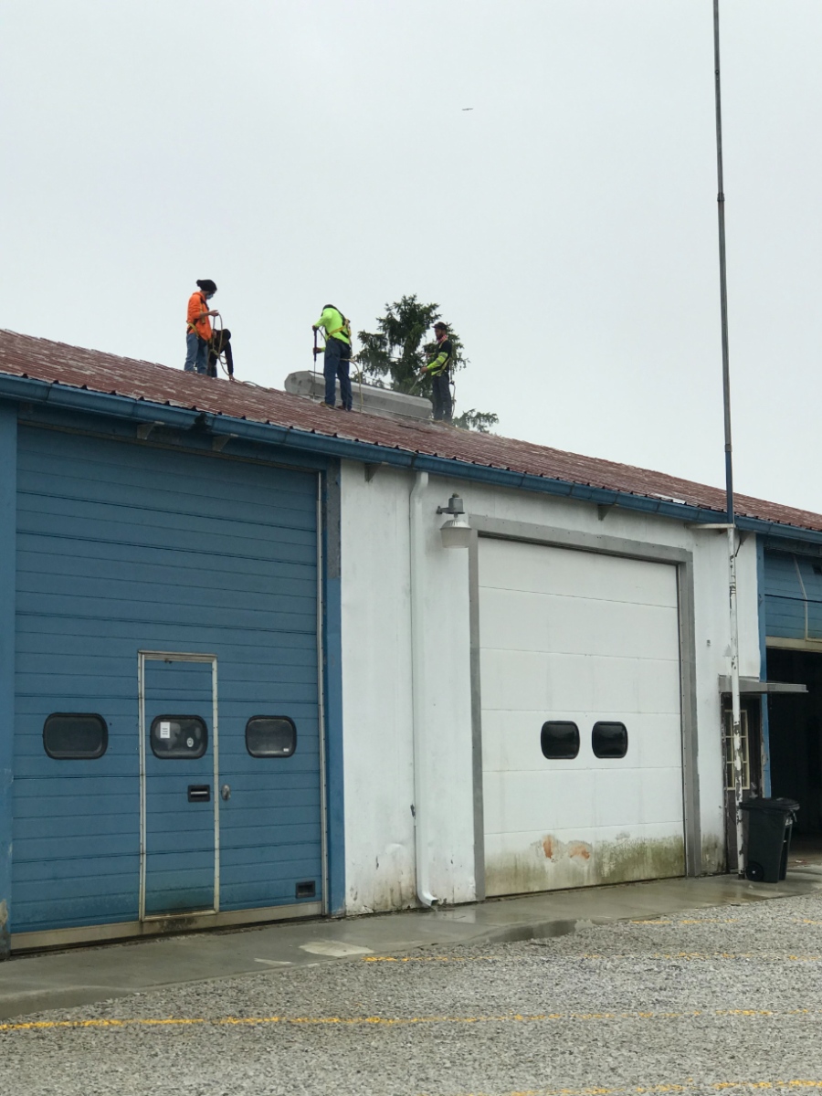 workers providing metal roof restoration