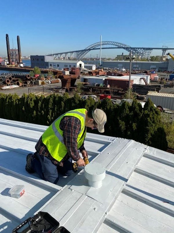 worker on a metal roofing system