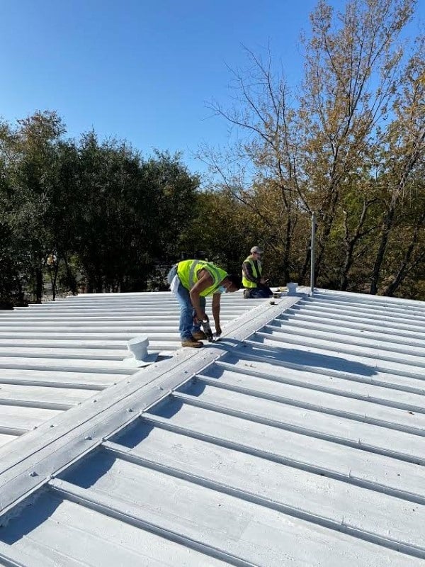 workers on a metal roofing system