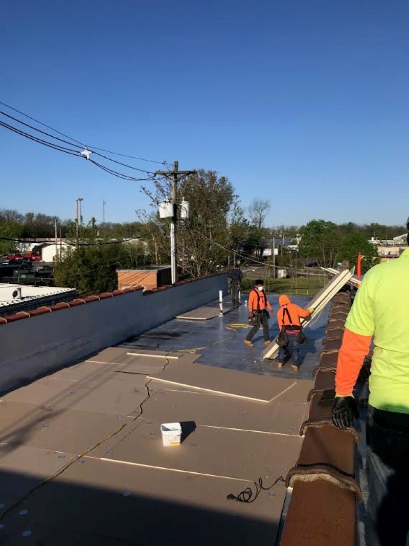 work being done on strip mall roofing