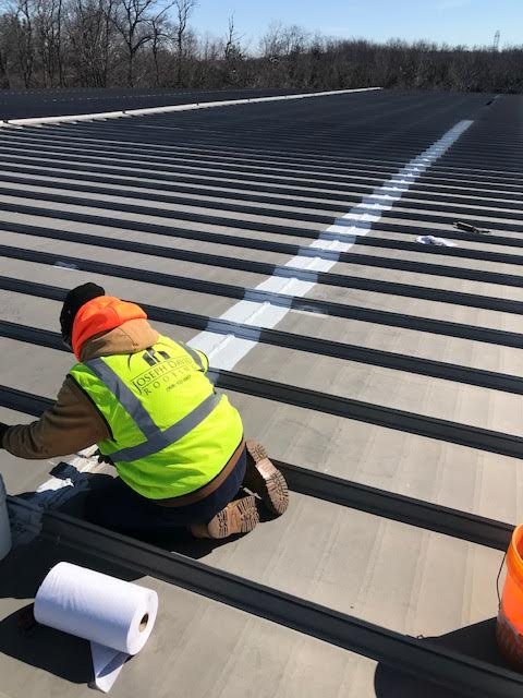 JDR crew making emergency repairs to a metal roof