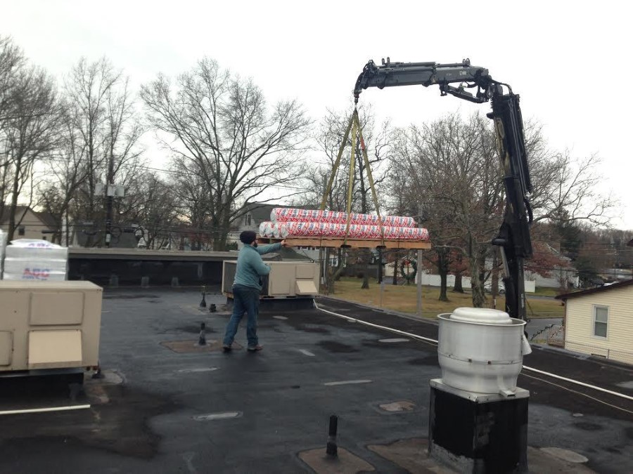 work being done on the roof of a strip mall