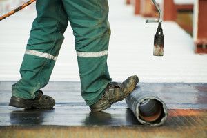 Flat roof covering repair works with roofing felt